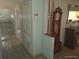 Hallway featuring vintage grandfather clock and access to kitchen area at 4607 N Saint Vincent St, Tampa, FL 33614