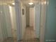 Hallway featuring mirrored wall and unique floor tiling at 4607 N Saint Vincent St, Tampa, FL 33614