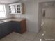 Simple kitchen with tile flooring, stainless steel sink and wood cabinets at 4607 N Saint Vincent St, Tampa, FL 33614