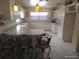 Well-equipped kitchen with custom cabinets, tiled floors, and a breakfast bar at 4607 N Saint Vincent St, Tampa, FL 33614