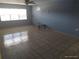 Empty living room with tiled floors, a window and a coffee table at 4607 N Saint Vincent St, Tampa, FL 33614
