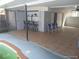 View of the outdoor tiled patio with a bar and partially enclosed pool at 4607 N Saint Vincent St, Tampa, FL 33614