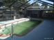 View of the large rectangular pool with a bar and chairs at 4607 N Saint Vincent St, Tampa, FL 33614