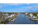 Aerial view of a canal community, showing the waterway, homes, and boat docks at 4964 Cedarbrook Ln, Hernando Beach, FL 34607
