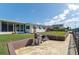 A single Gathering home exterior with a patio, two barbeque grills, and a well-manicured lawn at 4964 Cedarbrook Ln, Hernando Beach, FL 34607