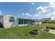 Expansive backyard featuring a fire pit, grill, and screened in porch perfect for outdoor relaxation at 4964 Cedarbrook Ln, Hernando Beach, FL 34607