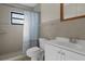 Standard bathroom featuring a shower with tiled walls, a toilet, and a vanity sink at 4964 Cedarbrook Ln, Hernando Beach, FL 34607