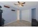 Cozy bedroom with tile floors, ceiling fan, double closet, and simple wall decor at 4964 Cedarbrook Ln, Hernando Beach, FL 34607