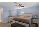 Comfortable bedroom with light blue walls, ceiling fan, and stylish white dresser with large mirror at 4964 Cedarbrook Ln, Hernando Beach, FL 34607