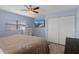 Inviting bedroom featuring a ceiling fan, closet, and a wall-mounted television for entertainment at 4964 Cedarbrook Ln, Hernando Beach, FL 34607