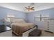 Comfortable bedroom with a ceiling fan, two windows, and a neutral color scheme at 4964 Cedarbrook Ln, Hernando Beach, FL 34607