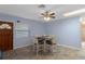 Cozy dining area featuring a ceiling fan, tile floors, and a stylish wooden door at 4964 Cedarbrook Ln, Hernando Beach, FL 34607