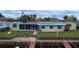Quaint waterfront home featuring an inviting outdoor area, canals, and charming curb appeal at 4964 Cedarbrook Ln, Hernando Beach, FL 34607