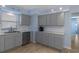 Well-designed kitchen featuring gray cabinets, subway tile backsplash, and modern finishes at 4964 Cedarbrook Ln, Hernando Beach, FL 34607