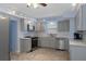 Modern kitchen featuring stainless steel appliances, gray cabinetry, and ample counter space at 4964 Cedarbrook Ln, Hernando Beach, FL 34607