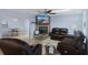 Open concept living room with fireplace and flat screen TV offers cozy seating and ceiling fan at 4964 Cedarbrook Ln, Hernando Beach, FL 34607