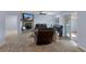 Relaxing living room features a brick fireplace with flat screen TV and comfy leather seating at 4964 Cedarbrook Ln, Hernando Beach, FL 34607