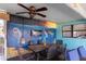 Unique patio featuring colorful underwater themed wall art and an outdoor dining set at 4964 Cedarbrook Ln, Hernando Beach, FL 34607