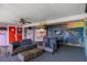 Outdoor patio with mural, seating area and kitchenette creating a unique entertaining space at 4964 Cedarbrook Ln, Hernando Beach, FL 34607