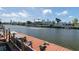 Waterfront property featuring a boat dock with bench seating, and a scenic canal view at 4964 Cedarbrook Ln, Hernando Beach, FL 34607