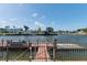 Waterfront property featuring a canal with multiple boat docks and beautiful sunny sky above at 4964 Cedarbrook Ln, Hernando Beach, FL 34607