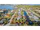 An aerial view showcases a charming single-story home with access to a canal and lush greenery at 5435 Quist Dr, Port Richey, FL 34668