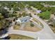 An aerial view shows the single Gathering home in a neighborhood with mature trees and a long driveway at 6250 Vermont Ave, New Port Richey, FL 34653