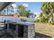 Outdoor grill and gray stone countertop are featured in the backyard at 6250 Vermont Ave, New Port Richey, FL 34653