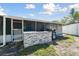 A stone countertop is visible adjacent to the screened in patio in the backyard at 6250 Vermont Ave, New Port Richey, FL 34653