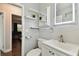 Clean bathroom showcasing a white vanity, modern faucet, an LED mirror and open shelving at 6250 Vermont Ave, New Port Richey, FL 34653