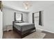 Comfortable bedroom showcasing hardwood floors, a modern ceiling fan, and serene natural light at 6250 Vermont Ave, New Port Richey, FL 34653