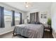 Tranquil bedroom offering natural light, neutral tones, hardwood floors and coordinating modern décor at 6250 Vermont Ave, New Port Richey, FL 34653