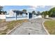 Charming single Gathering home, front view with driveway, featuring mature trees and inviting curb appeal at 6250 Vermont Ave, New Port Richey, FL 34653