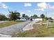 Charming single Gathering home, front view with driveway, featuring mature trees and inviting curb appeal at 6250 Vermont Ave, New Port Richey, FL 34653