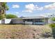 A gray house with white trim and a screened-in patio are visible in the backyard at 6250 Vermont Ave, New Port Richey, FL 34653