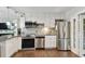 White cabinets and stainless steel appliances outfit the newly updated kitchen at 6250 Vermont Ave, New Port Richey, FL 34653
