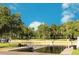Picturesque waterfront view with lush trees and boat docks under a bright blue sky at 6250 Vermont Ave, New Port Richey, FL 34653