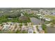 An aerial view showcases homes near picturesque ponds, lush natural landscapes, and convenient roadways at 7239 Sharpsburg Blvd, New Port Richey, FL 34653