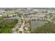 Community aerial showcasing multiple ponds, diverse housing, green spaces, and commercial area nearby at 7239 Sharpsburg Blvd, New Port Richey, FL 34653