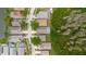An aerial view shows well-maintained homes, some with private pools, along a quiet street next to green spaces and a lake at 7239 Sharpsburg Blvd, New Port Richey, FL 34653