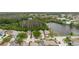 An aerial view highlights homes, verdant landscaping, private pools and access to a scenic pond at 7239 Sharpsburg Blvd, New Port Richey, FL 34653