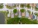 Aerial view of a residential neighborhood featuring well-kept lawns and mature trees near a tranquil lake setting at 7239 Sharpsburg Blvd, New Port Richey, FL 34653