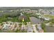 Wide aerial view of the property located in a peaceful neighborhood near a lake at 7239 Sharpsburg Blvd, New Port Richey, FL 34653
