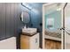 Bathroom with dark wood paneling, a modern sink, and a door to the Primary bedroom at 7239 Sharpsburg Blvd, New Port Richey, FL 34653