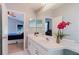 Bright bathroom featuring a double sink vanity and an adjoining bedroom view at 7239 Sharpsburg Blvd, New Port Richey, FL 34653