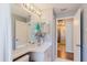 Clean bathroom with a vanity area with dual mirrors and lighting, and an open doorway at 7239 Sharpsburg Blvd, New Port Richey, FL 34653