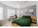 Cozy bedroom with a sleek bed, modern desk, and bright windows offering plenty of light at 7239 Sharpsburg Blvd, New Port Richey, FL 34653