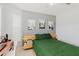 Bedroom with a wooden bed, green comforter, and a desk next to the window at 7239 Sharpsburg Blvd, New Port Richey, FL 34653