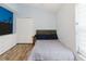 Bedroom with light walls, wood floor, and large closet, creating a comfortable retreat at 7239 Sharpsburg Blvd, New Port Richey, FL 34653