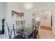 Open dining room with a glass table, chandelier, and an arched entry to the kitchen at 7239 Sharpsburg Blvd, New Port Richey, FL 34653